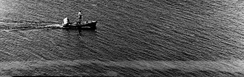 File:Lone boat fisherman with net.jpg